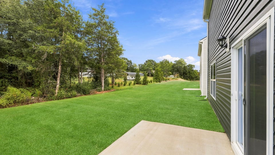 Back exterior of home with patio.