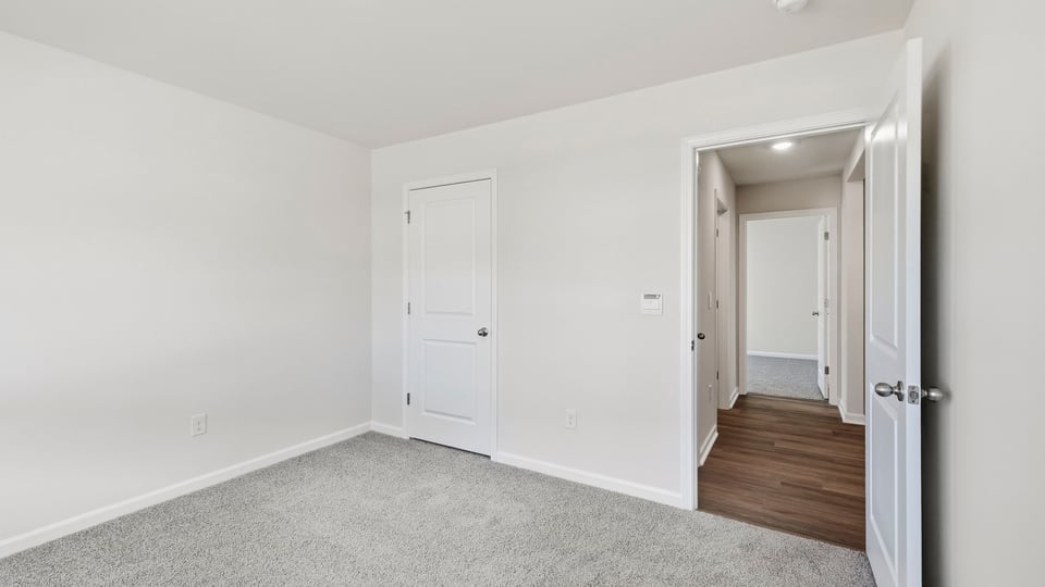 Bedroom with carpet and window.