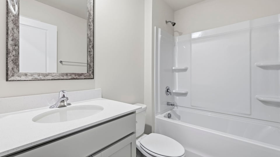 Bathroom with single vanity sink and bathtub.