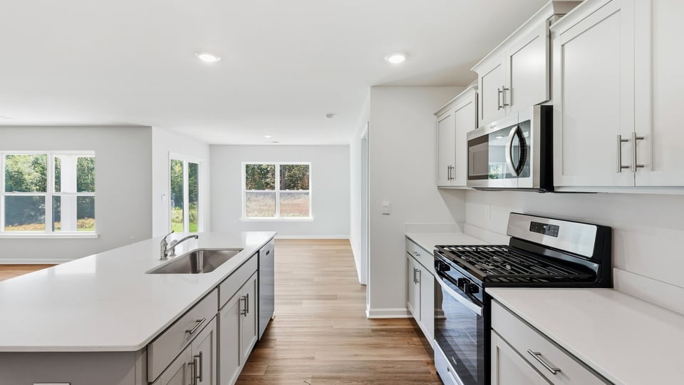 Kitchen and island and stainless steel appliances.