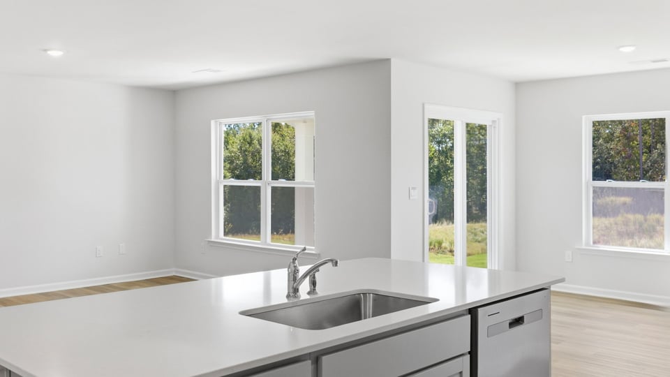 Kitchen and island and stainless steel appliances.