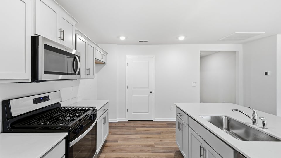 Kitchen and island and stainless steel appliances.