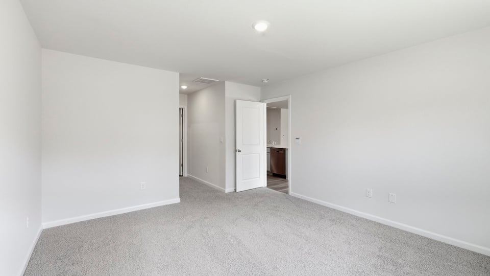 Bedroom with carpet and window.