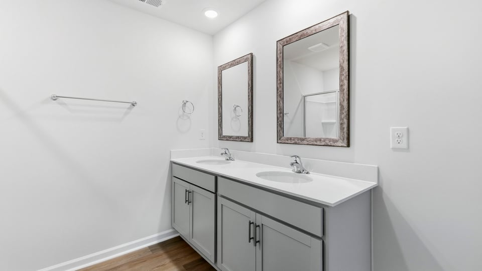 View of bathroom and double vanity sink.