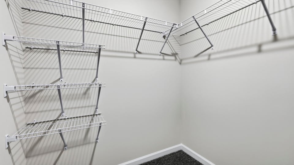 Closet with hanging storage racks.