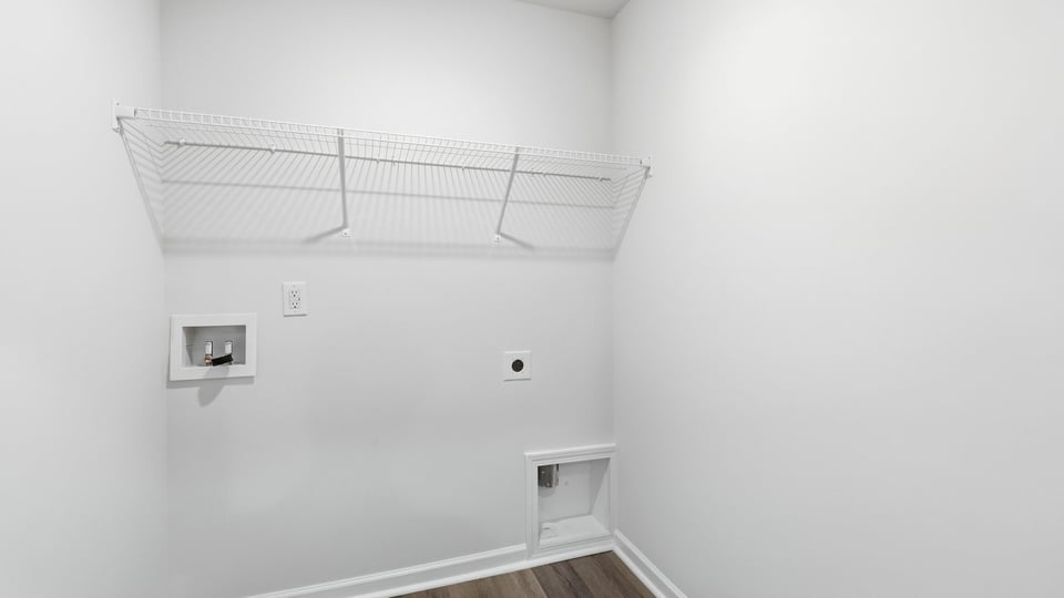 Laundry room with hanging storage racks.