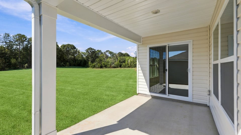 Back exterior of home with covered patio.