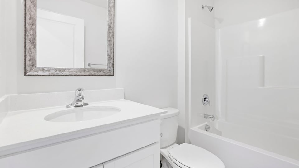 Bathroom with single vanity sink and bathtub.