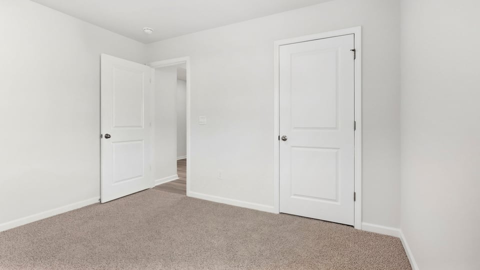 Bedroom with carpet and window.