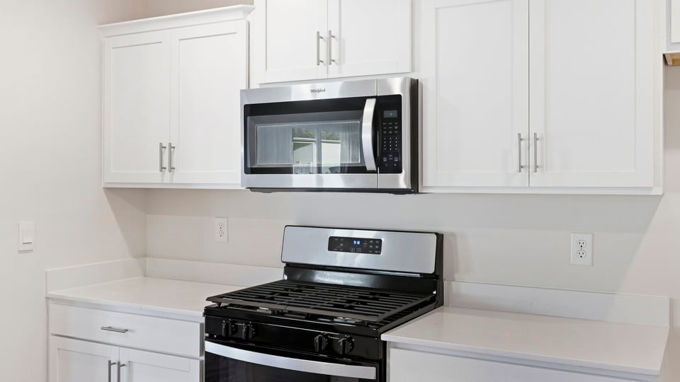 Kitchen and island with quartz countertops.