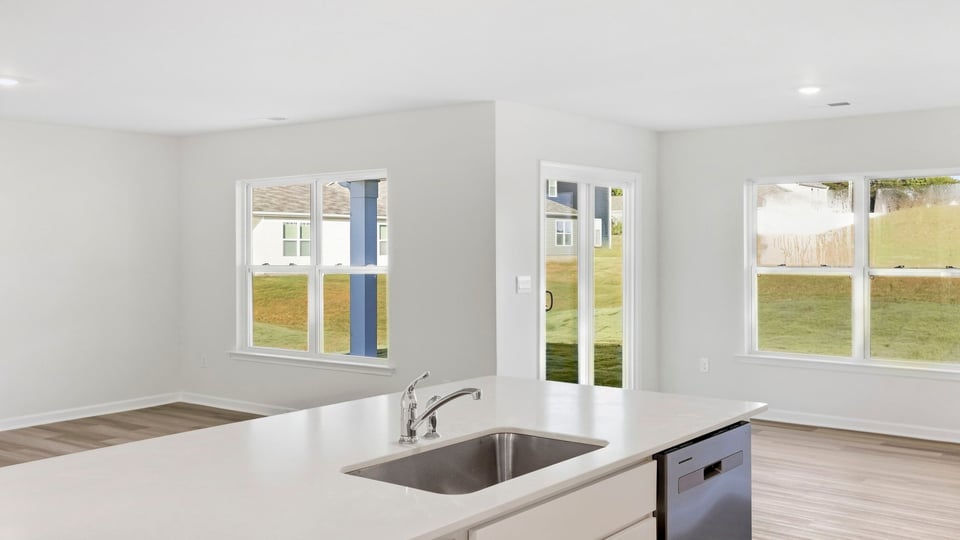 Kitchen and island with quartz countertops.