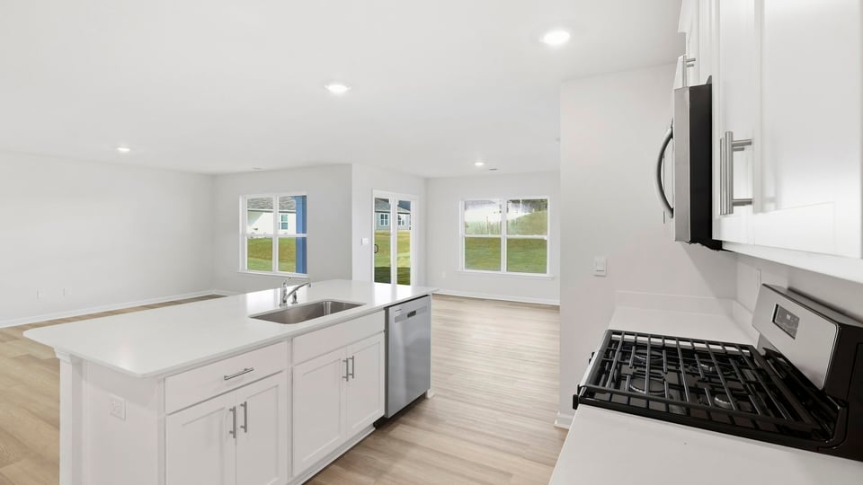 Kitchen and island with quartz countertops.