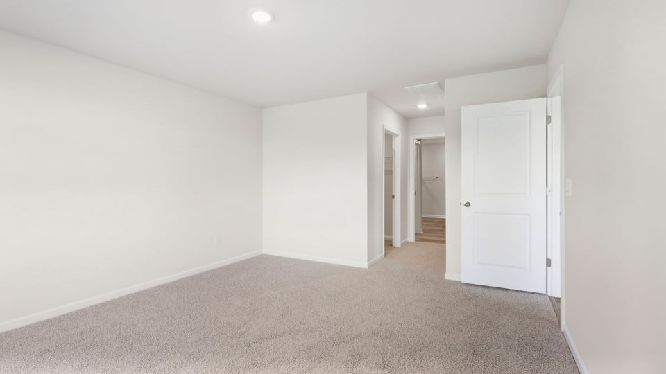 Bedroom with carpet and window.