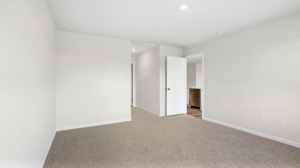 Bedroom with carpet and window.