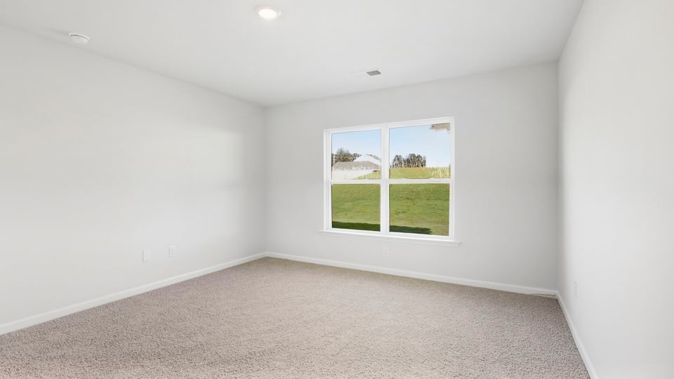 Bedroom with carpet and window.