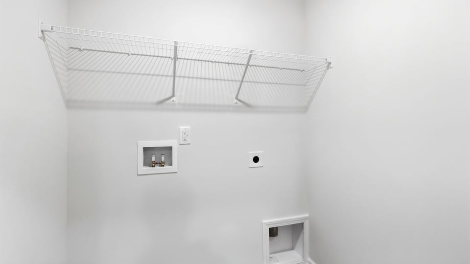 Laundry room with hanging storage racks.