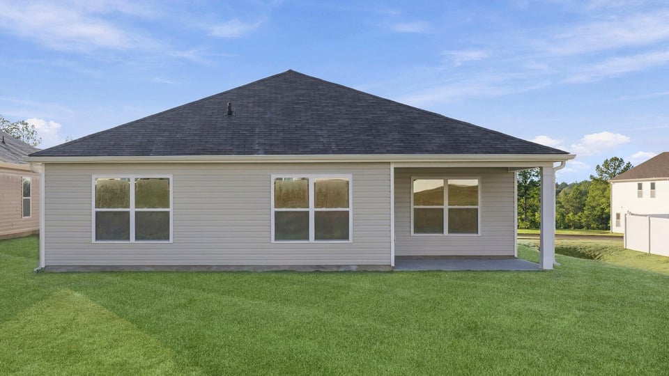 Back exterior of home with large backyard.