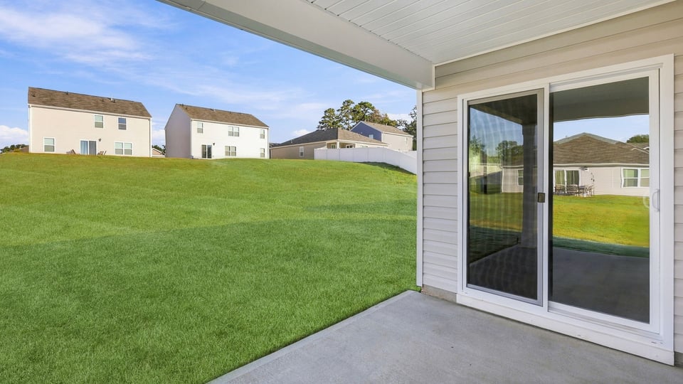 Back exterior of home with patio.