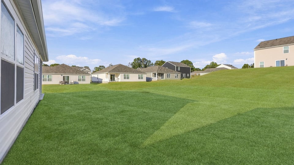 Back exterior of home with large backyard.