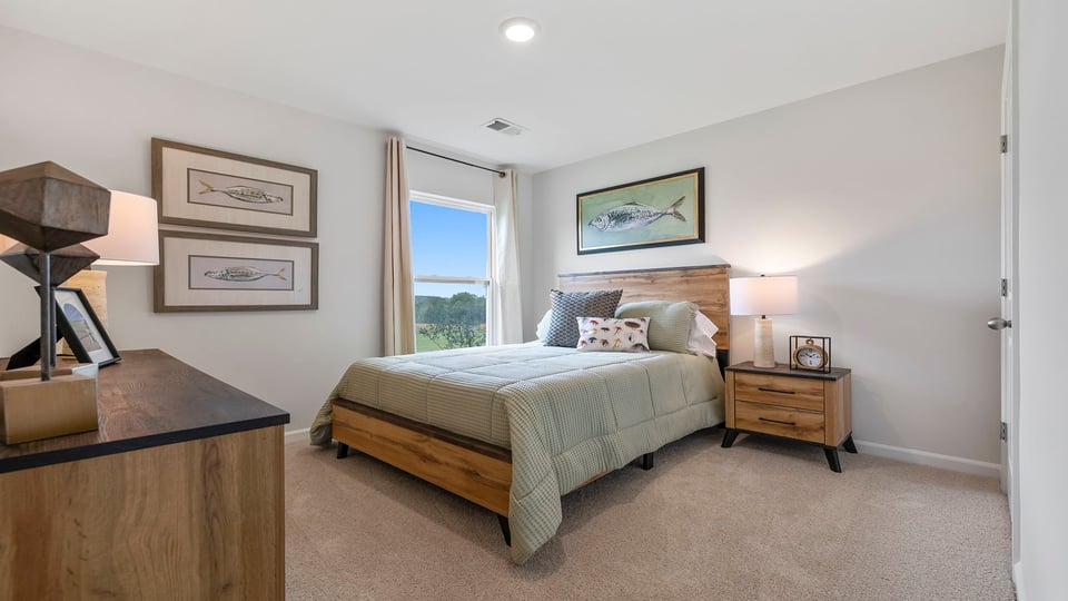 Bedroom with carpet and windows.