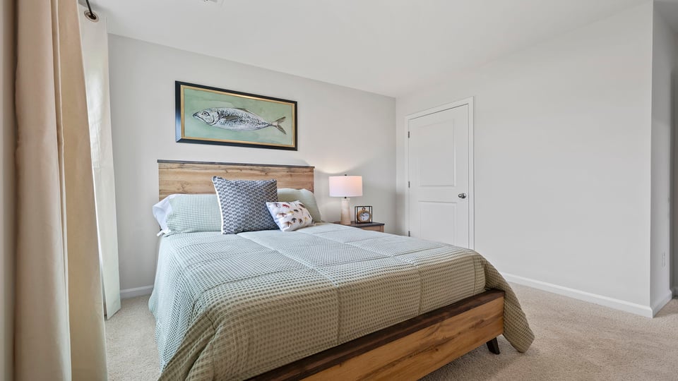 Bedroom with carpet and windows.
