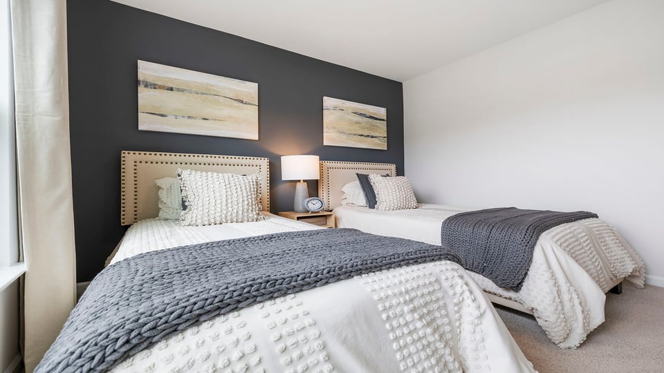 Bedroom with carpet and windows.