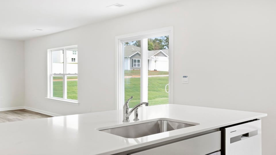 Kitchen and island with quartz countertops.