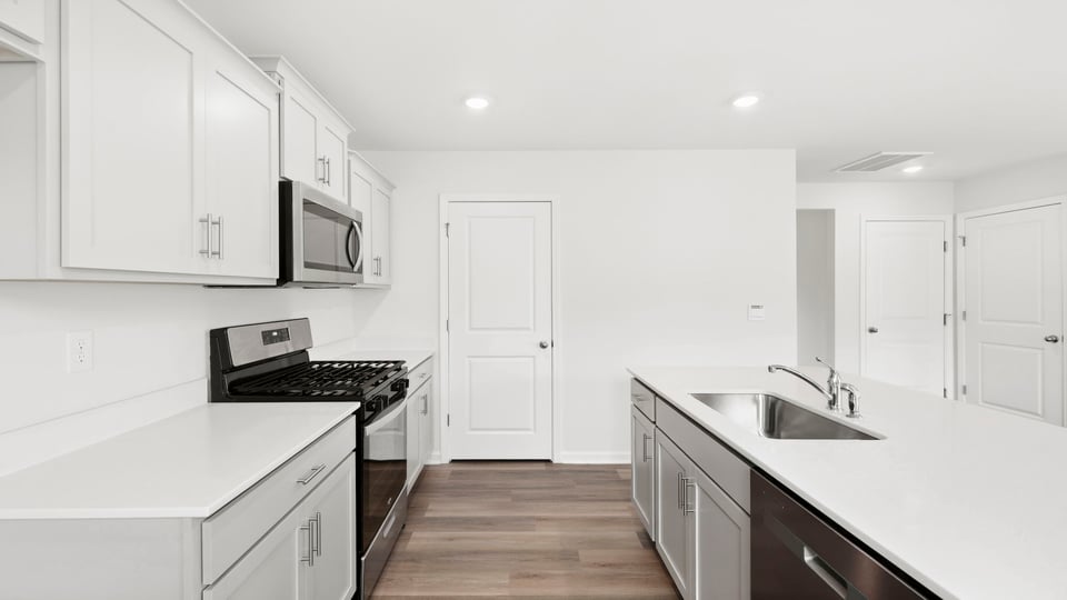 Kitchen and island with quartz countertops.