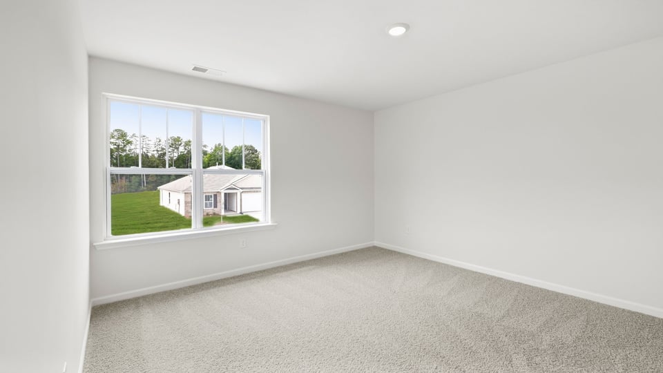 Bedroom with carpet and windows.