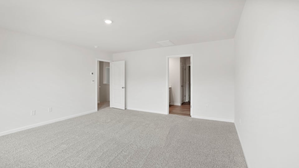 Bedroom with carpet and windows.