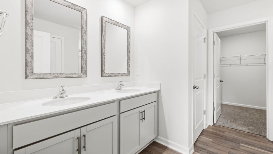 Bathroom with double vanity sink and closet.