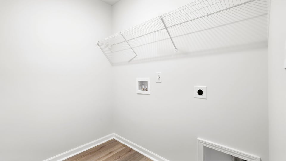Laundry room with hanging storage racks.