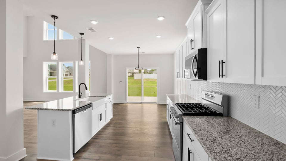 Kitchen and island with stainless steel appliances.