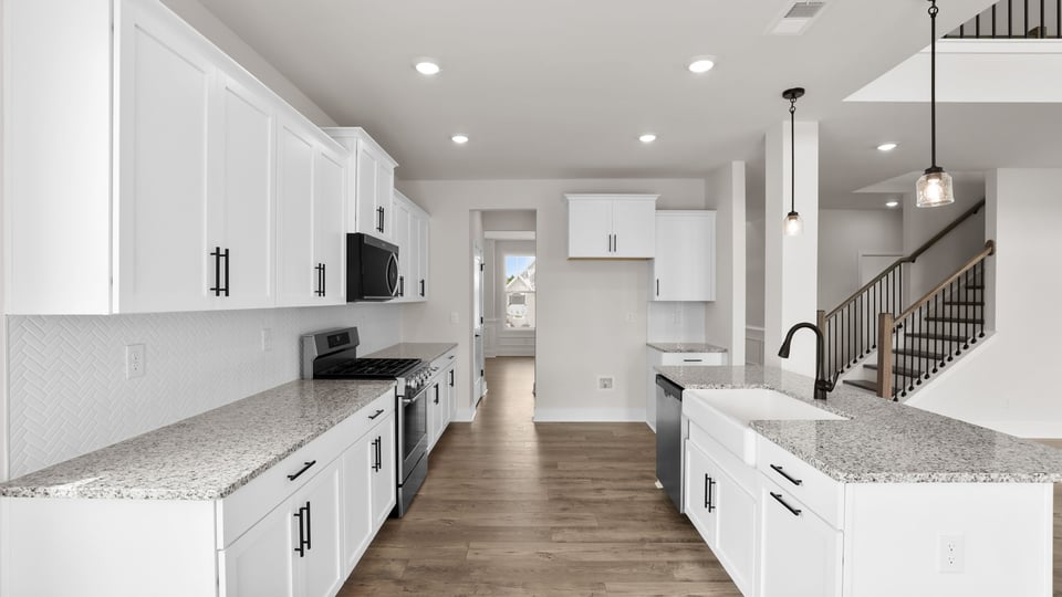 Kitchen and island with stainless steel appliances.