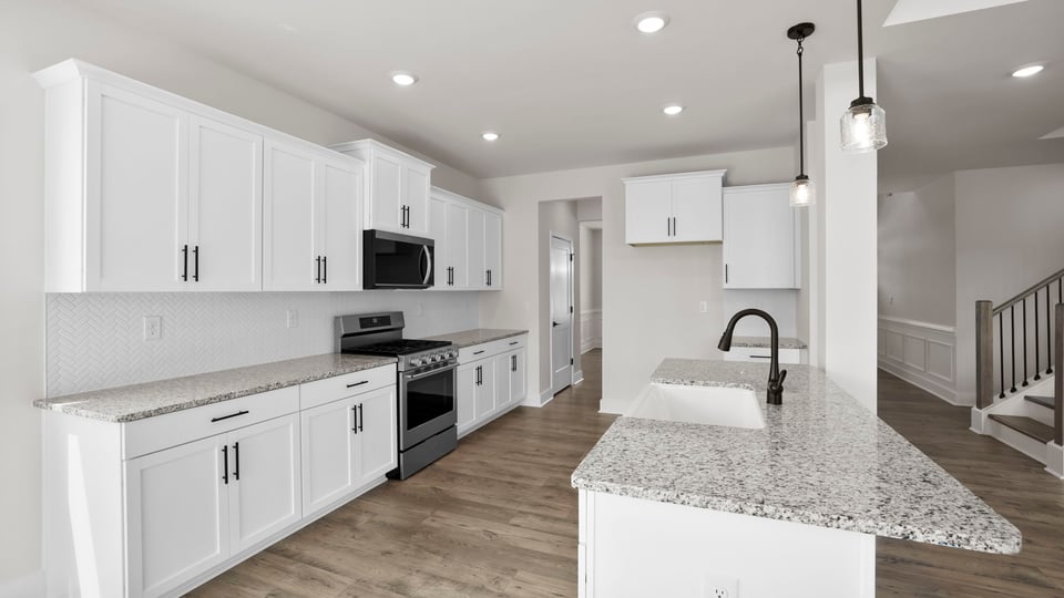 Kitchen and island with stainless steel appliances.