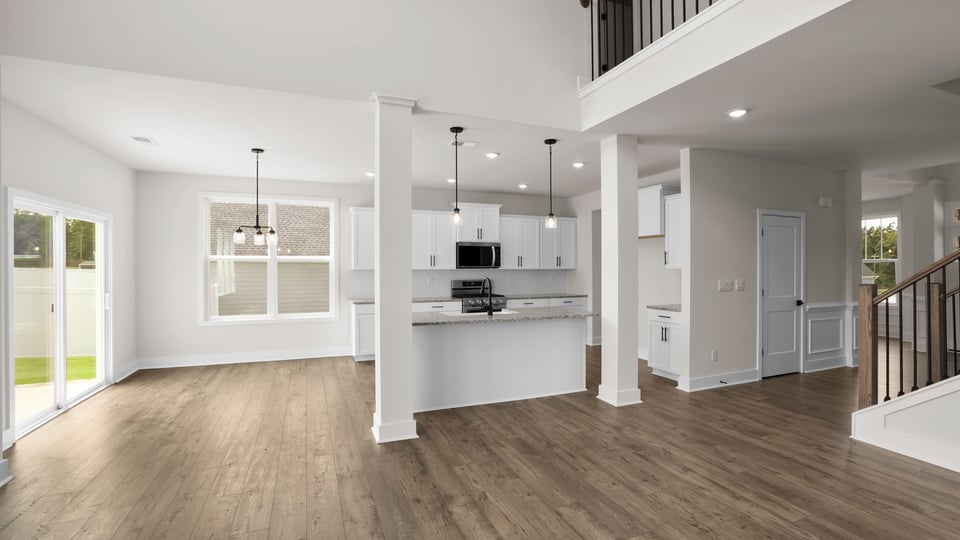 Kitchen and island with stainless steel appliances.