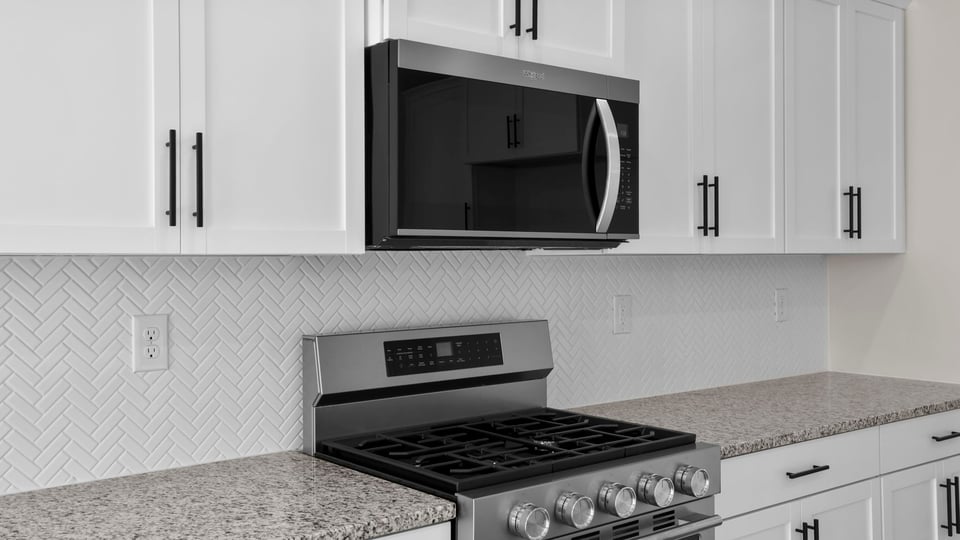 Kitchen and island with stainless steel appliances.