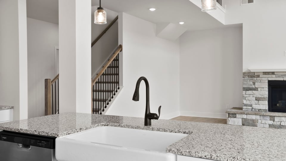 Kitchen and island with stainless steel appliances.