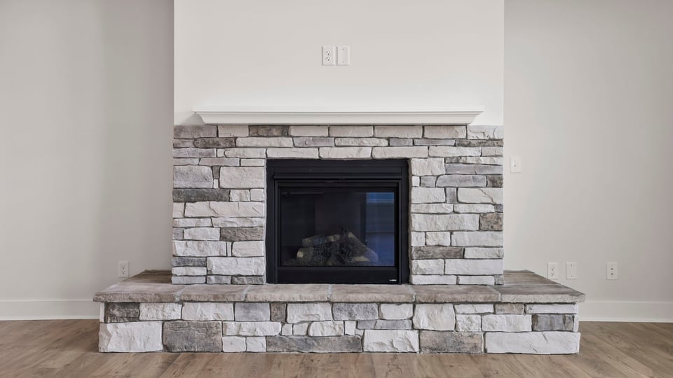 Living room with fireplace and window.