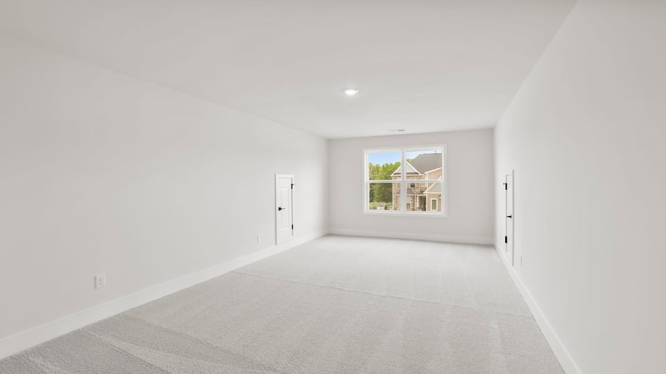 Bedroom with carpet and window.