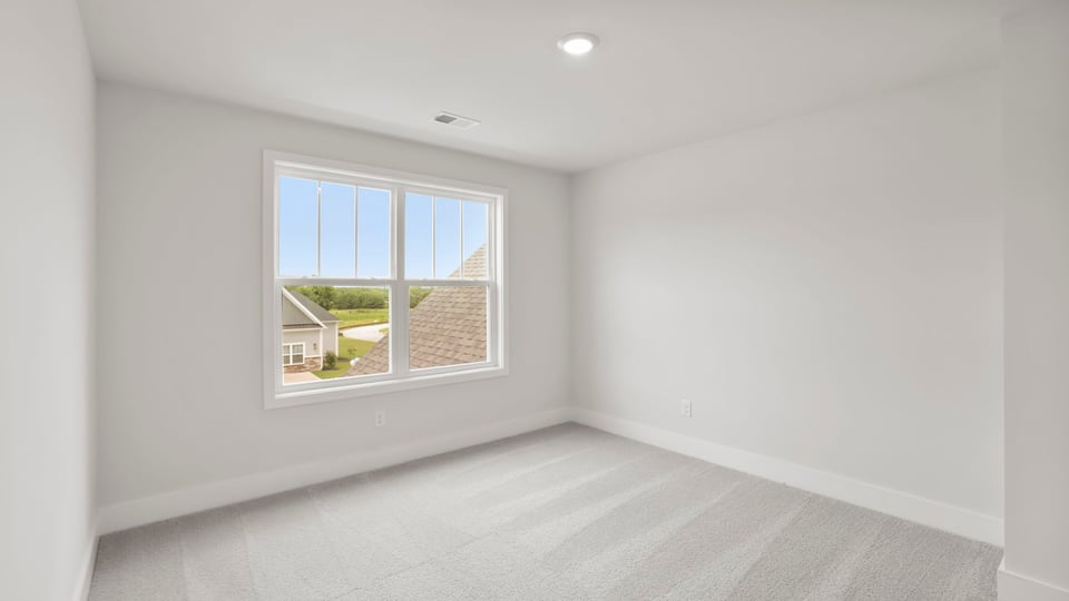 Bedroom with carpet and window.