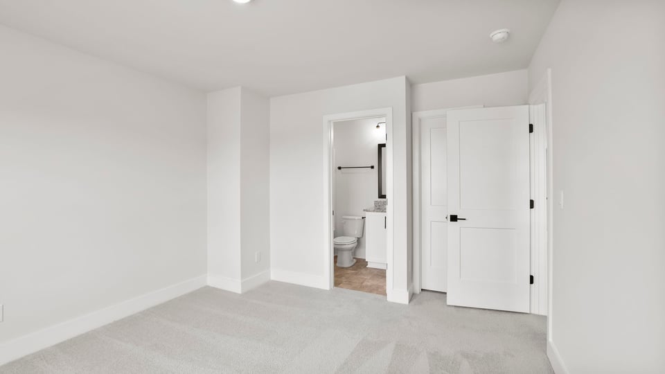 Bedroom with carpet and window.