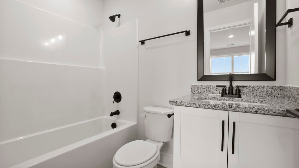 Hal bathroom with single vanity sink and bathtub.