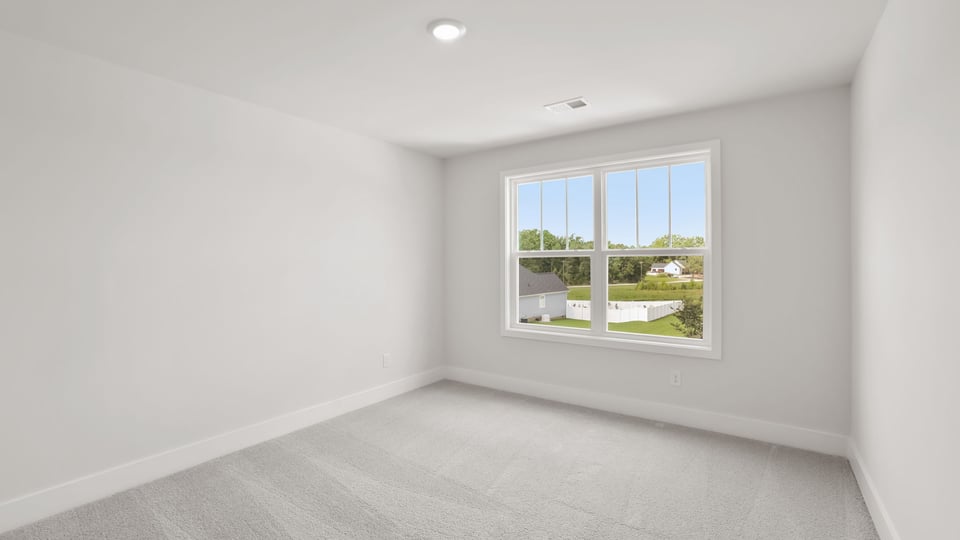 Bedroom with carpet and window.