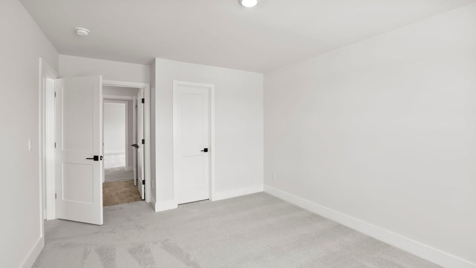 Bedroom with carpet and window.