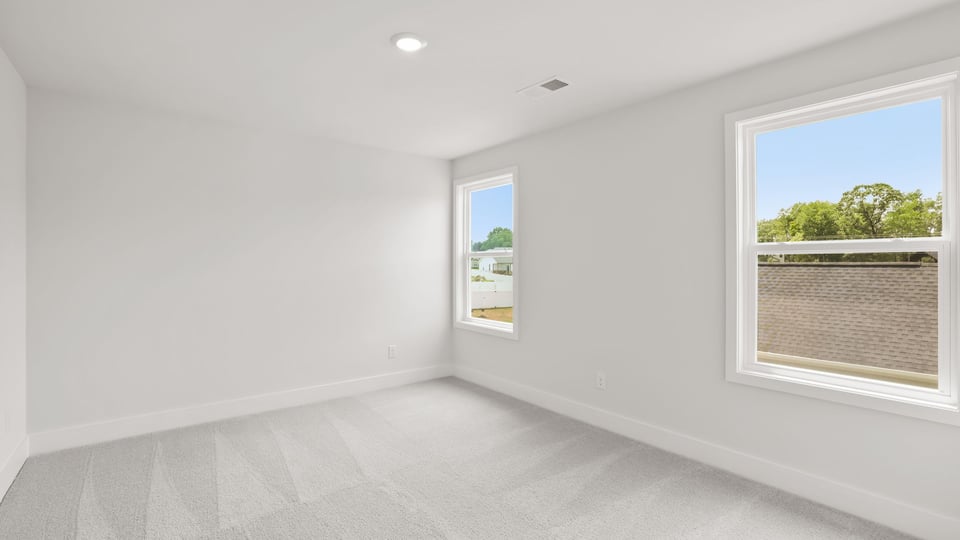 Bedroom with carpet and window.