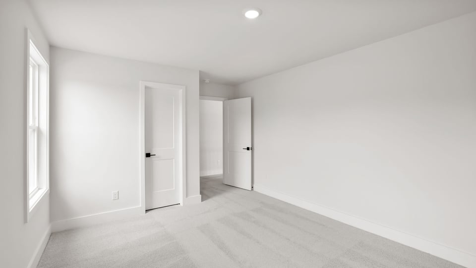 Bedroom with carpet and window.