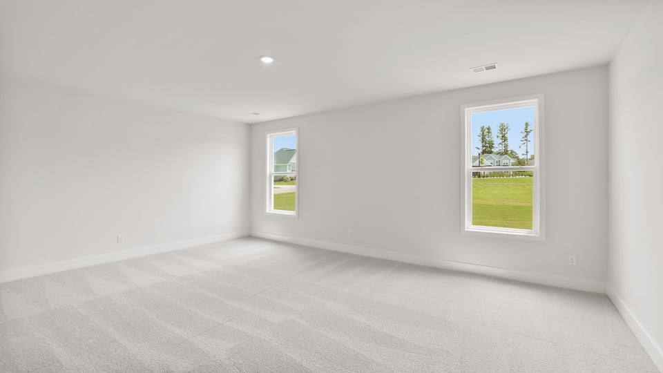 Bedroom with carpet and window.