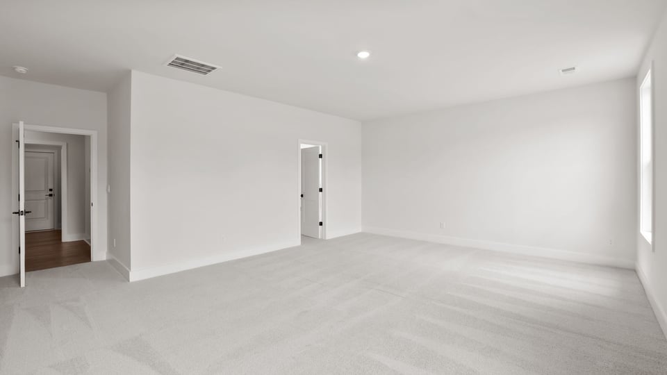 Bedroom with carpet and window.