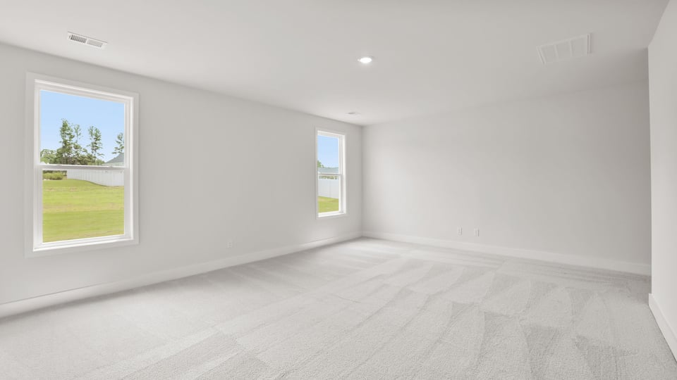Bedroom with carpet and window.